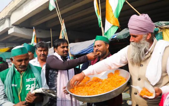 Farmers distribute sweets after PM Modi announced to repeal farm laws on Nov. 19